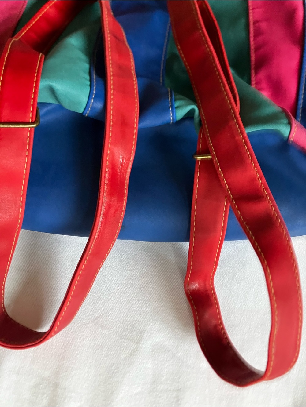 Vintage 1980s Multicolor Leather Backpack buckle straps and leather drawstring.